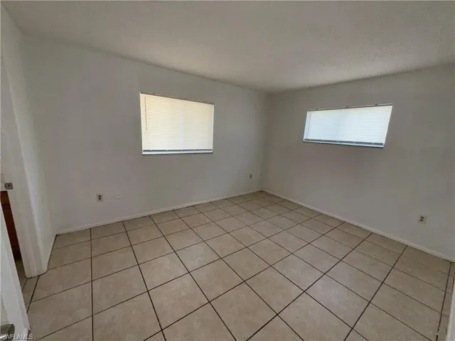 Unfurnished room with light tile patterned floors and a textured ceiling