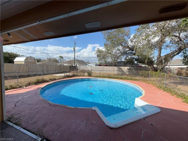 View of pool with a fenced backyard and patio surround
