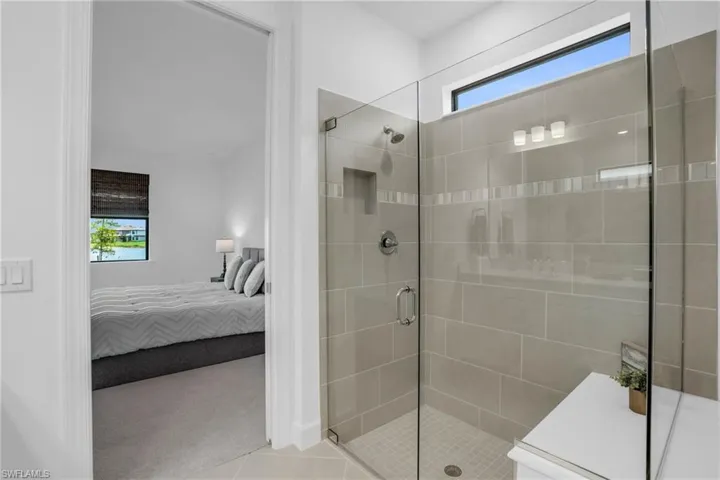 Bathroom featuring a wealth of natural light, tile patterned flooring, and walk in shower