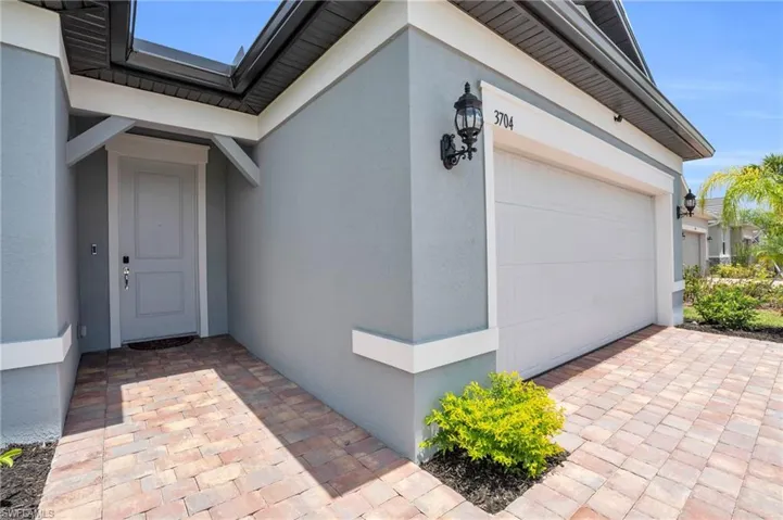 View of exterior entry with a garage