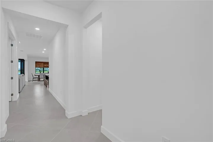 Hall featuring light tile patterned floors