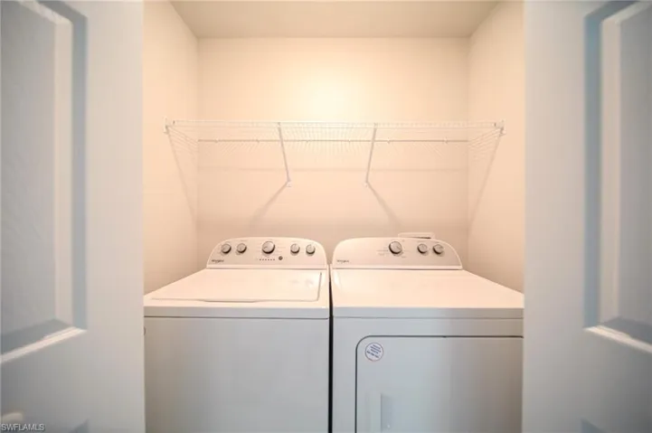 The Laundry Room Has A Brand New Washer And Dryer And Metal Shelving!