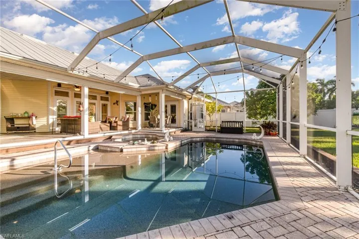 View of pool with a lanai, outdoor lounge area, a sunroom, and a patio area