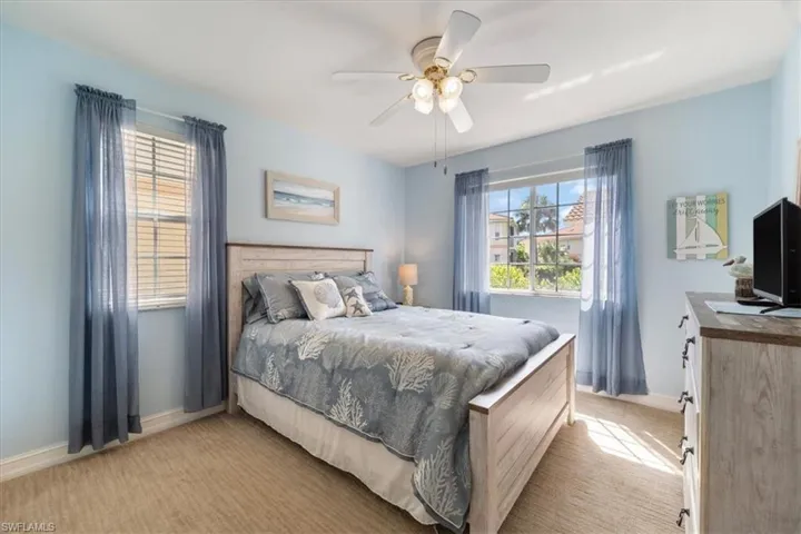 Bedroom with light carpet and ceiling fan