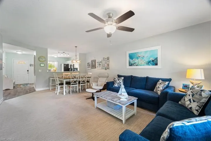 Living room featuring carpet floors and ceiling fan
