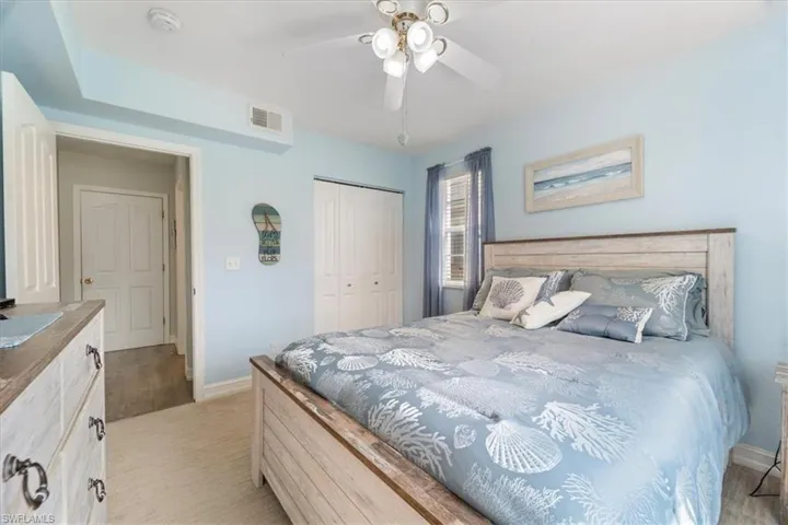 Bedroom with a closet, ceiling fan, and light wood finished floors