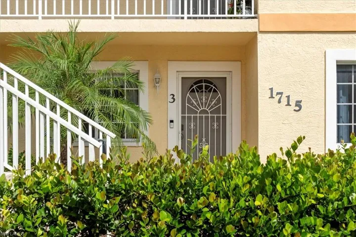 Doorway to property with stucco siding