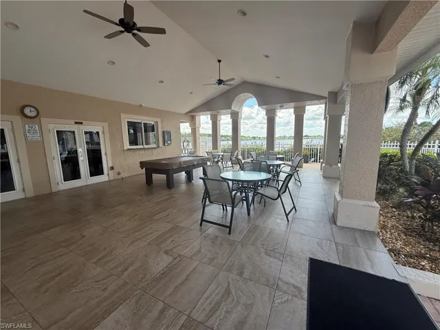 View of patio with outdoor dining area, ceiling fan, and french doors