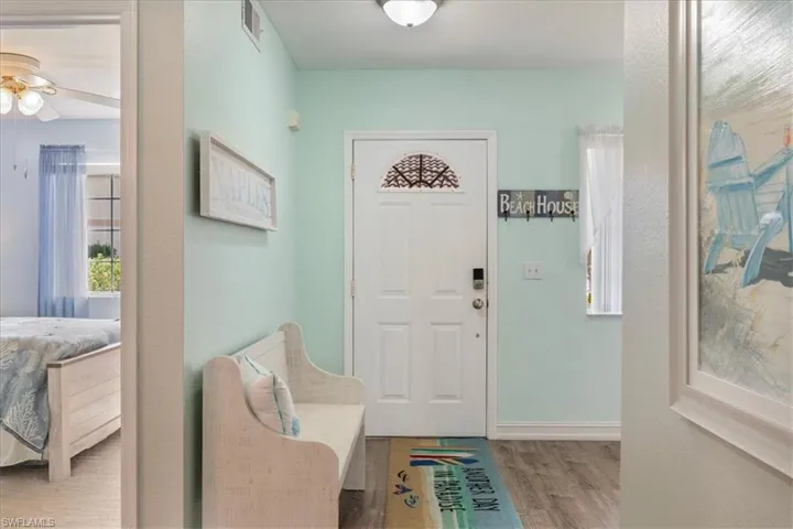 Entrance foyer with wood finished floors and ceiling fan