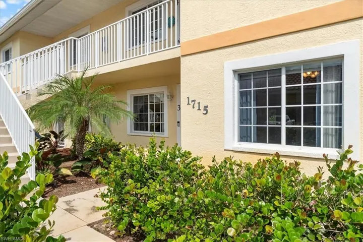 View of exterior entry with stucco siding and a balcony