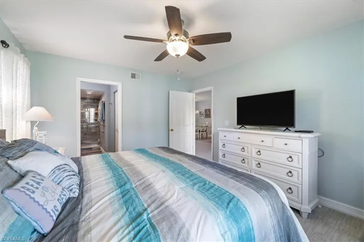 Bedroom with ceiling fan and ensuite bath