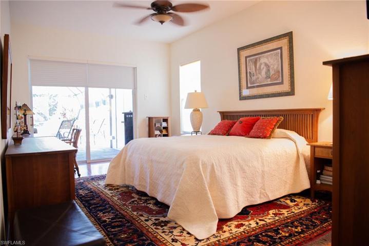 Master bedroom with sliders leading out to the lanai area.  Hardwood floors in all the bedrooms.