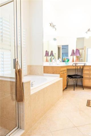 Master bathroom with dual sinks, make up sit down area, separate tub and shower.