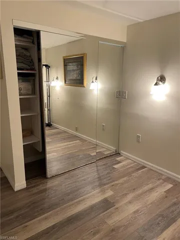 Unfurnished bedroom with hardwood / wood-style flooring