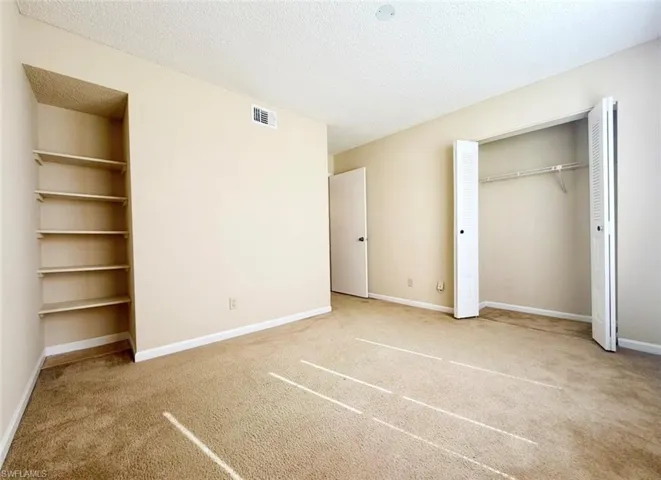 3rd bedroomflooring, a textured ceiling, baseboards, and visible vents