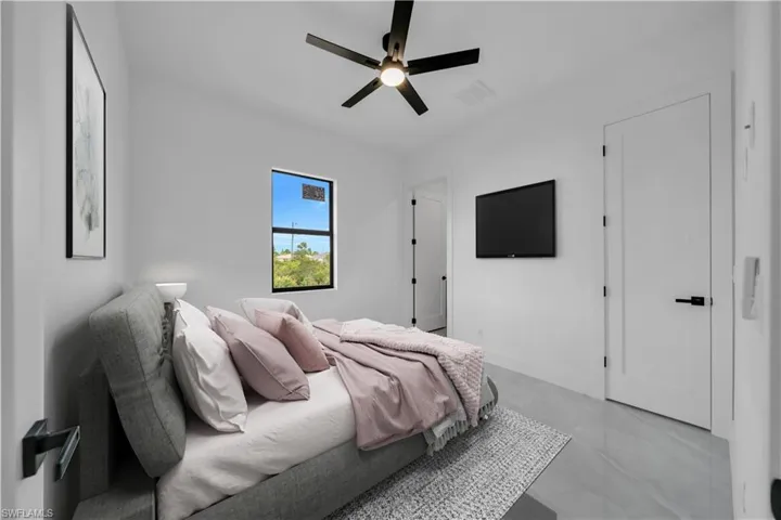Bedroom featuring a ceiling fan and baseboards