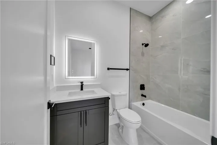 Full bath featuring vanity and shower / bathtub combination