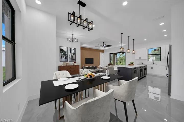 Dining area featuring recessed lighting, ceiling fan, and a chandelier