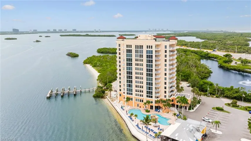 Drone / aerial view of a large body of water and apartment complex