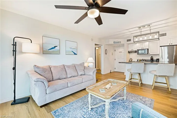 Living room featuring light wood finished floors and a ceiling fan