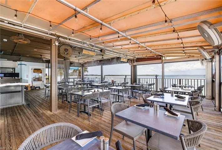 Deck with a water view and outdoor dining area