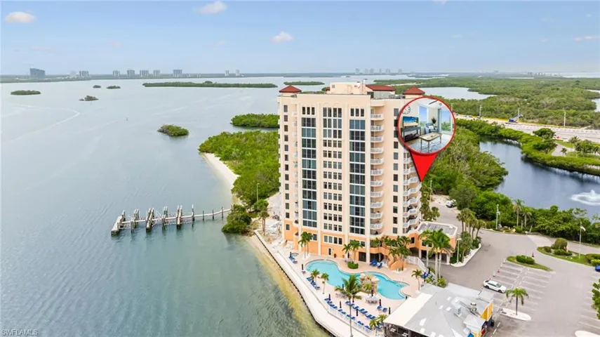 Drone / aerial view of a large body of water and a pool area