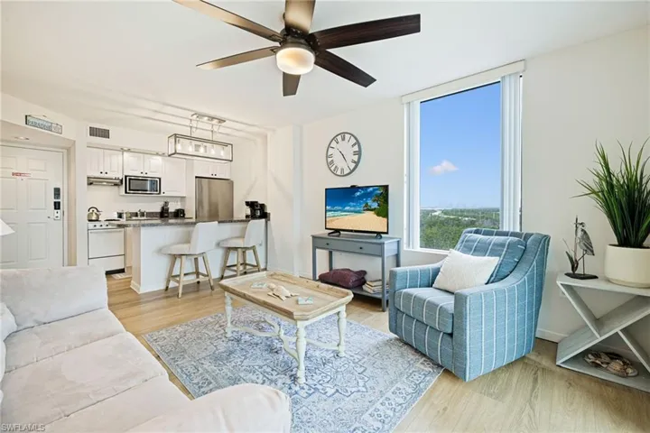 Living room featuring ceiling fan and light wood-type flooring