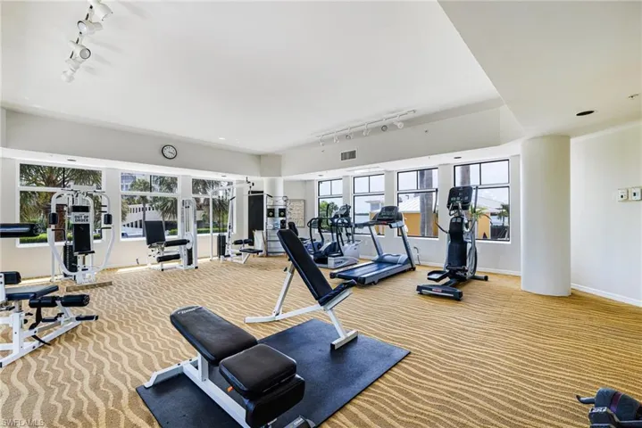 Gym with track lighting, carpet flooring, and french doors