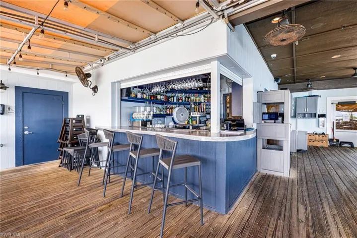 Indoor bar featuring wood-type flooring