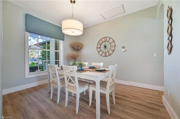 Dining area with light wood-style flooring and baseboards