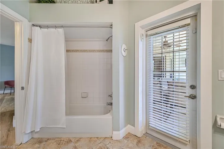 Bathroom with baseboards and shower / bath combo