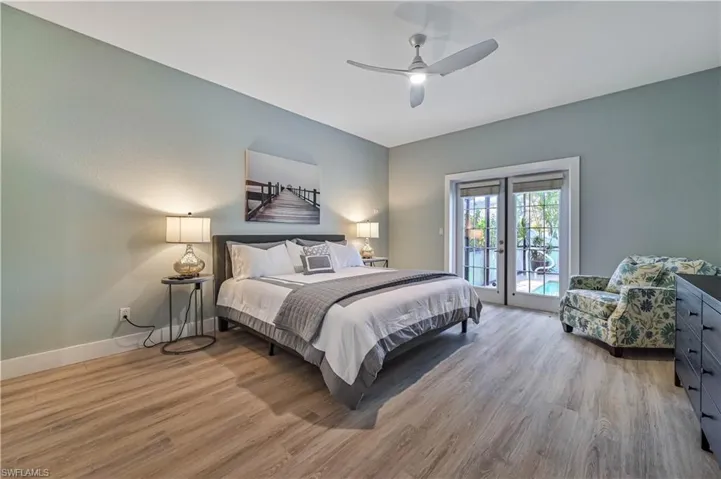 Bedroom with access to outside, wood finished floors, baseboards, and ceiling fan