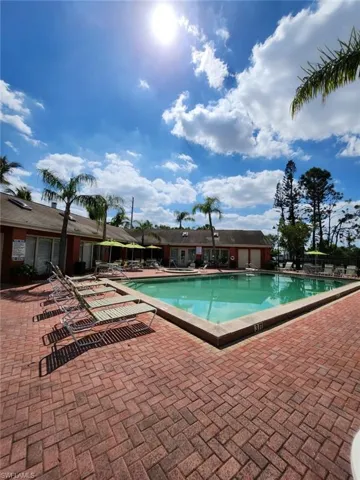 Community pool with a patio