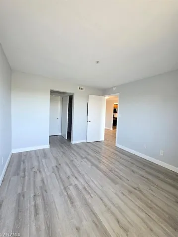 Unfurnished room featuring baseboards and light wood-style floors