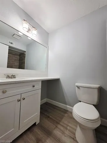 Walk in closet with light wood-style flooring