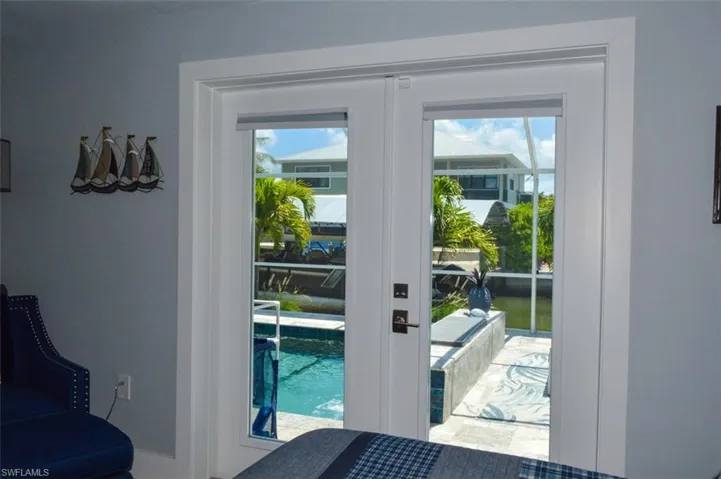 Doorway with plenty of natural light and french doors over looking pool area