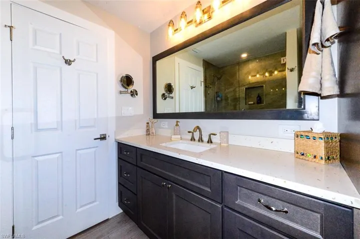 Bathroom featuring vanity, and tiled shower