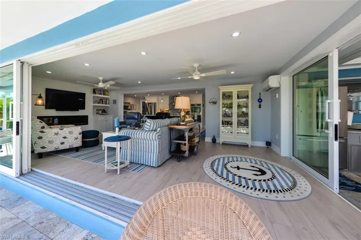 Living room with an AC wall unit, ceiling fan