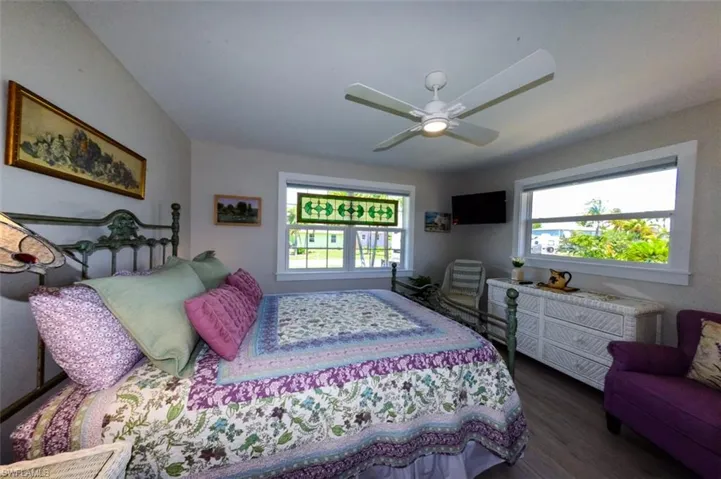 Guest bedroom with lots of natural light and a ceiling fan