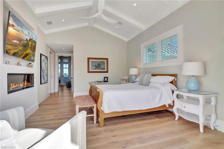 Bedroom with beam ceiling, high vaulted ceiling, wooden ceiling, and light hardwood / wood-style flooring