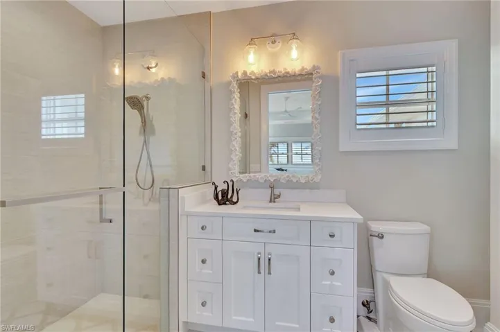 Bathroom with vanity, toilet, and walk in shower