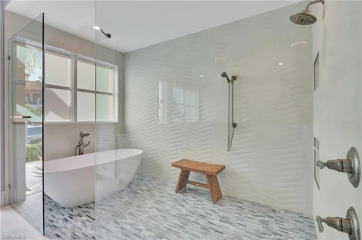 Bathroom with separate shower and tub and tile patterned flooring