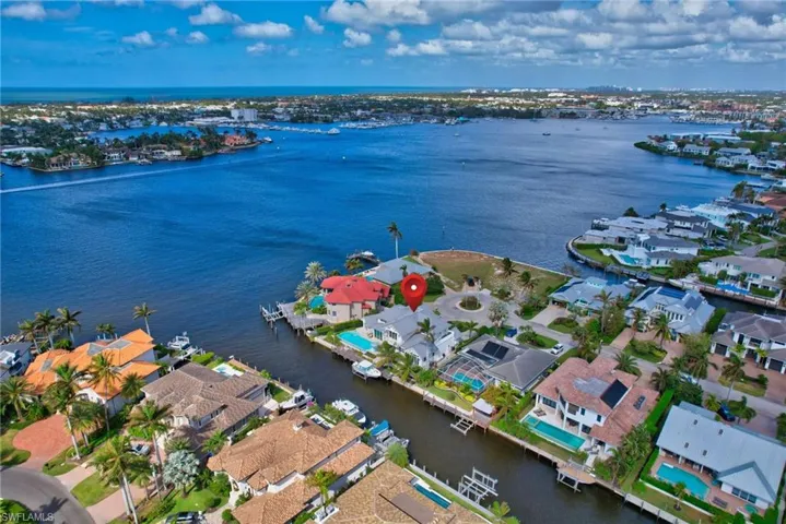 Birds eye view of property with a water view