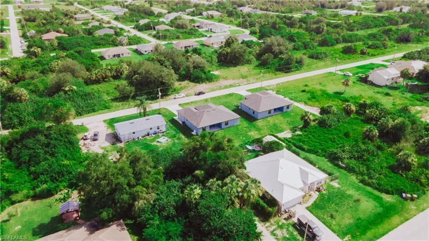 Aerial view of residential area featuring a tree filled landscape