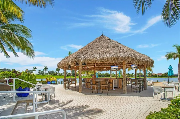 View of home's community with a patio area, a water view, a bar, and a gazebo