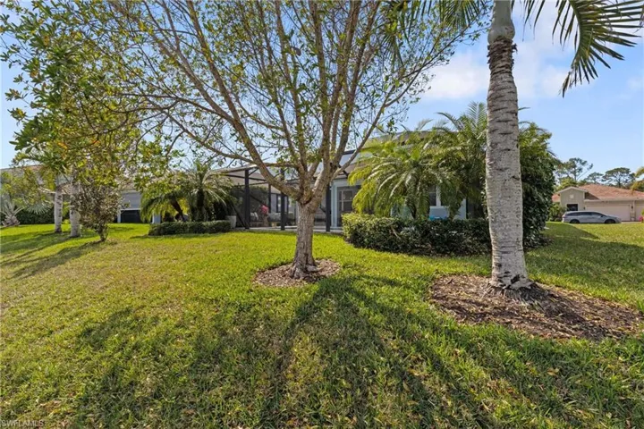 View of yard featuring glass enclosure