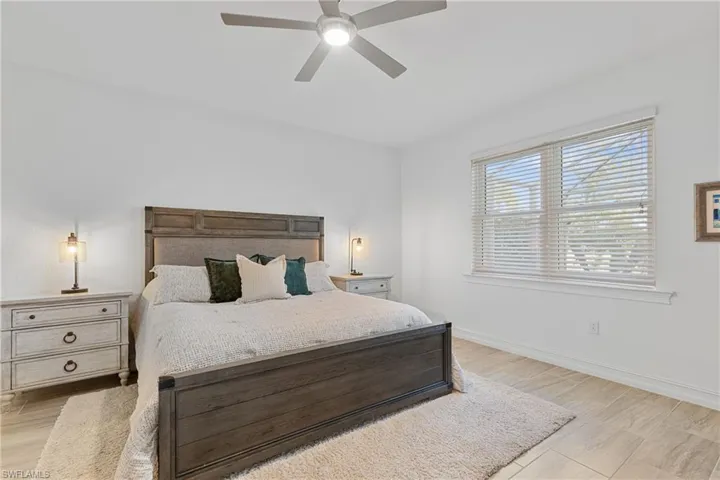 Bedroom with ceiling fan and light wood-type flooring