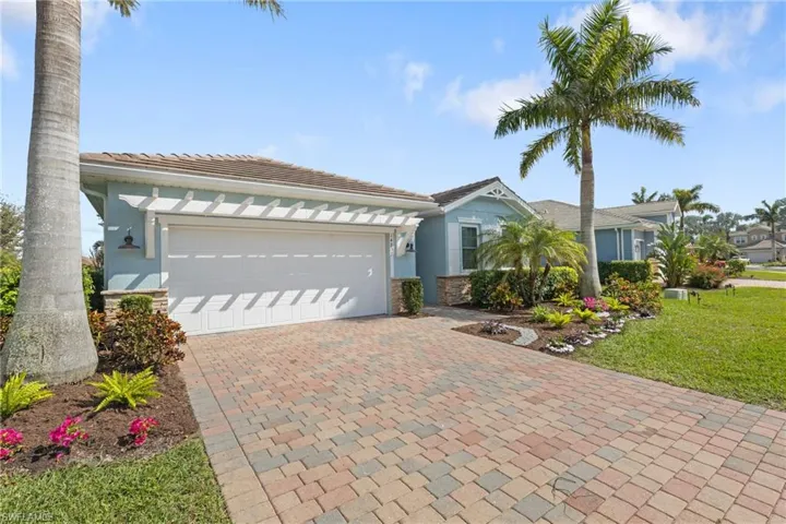 View of front of property featuring a garage and a front yard