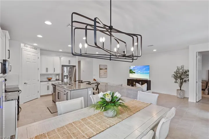 Tiled dining room featuring sink