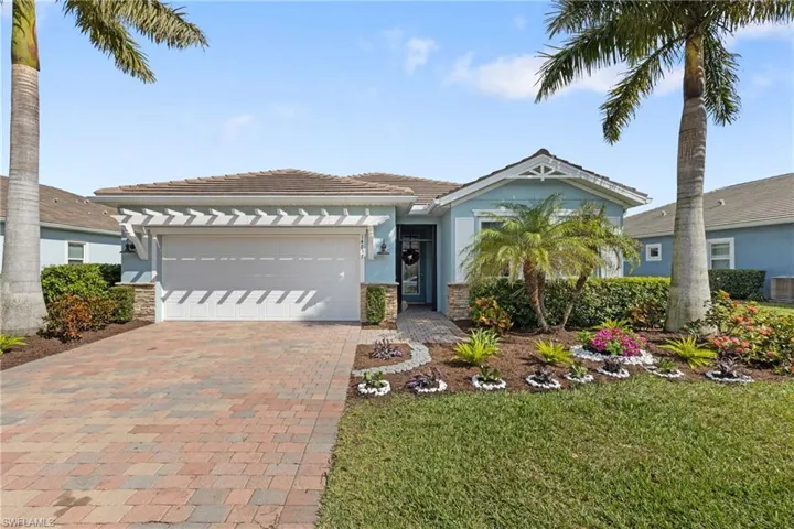 View of front of property with a garage, a front yard, and central air condition unit